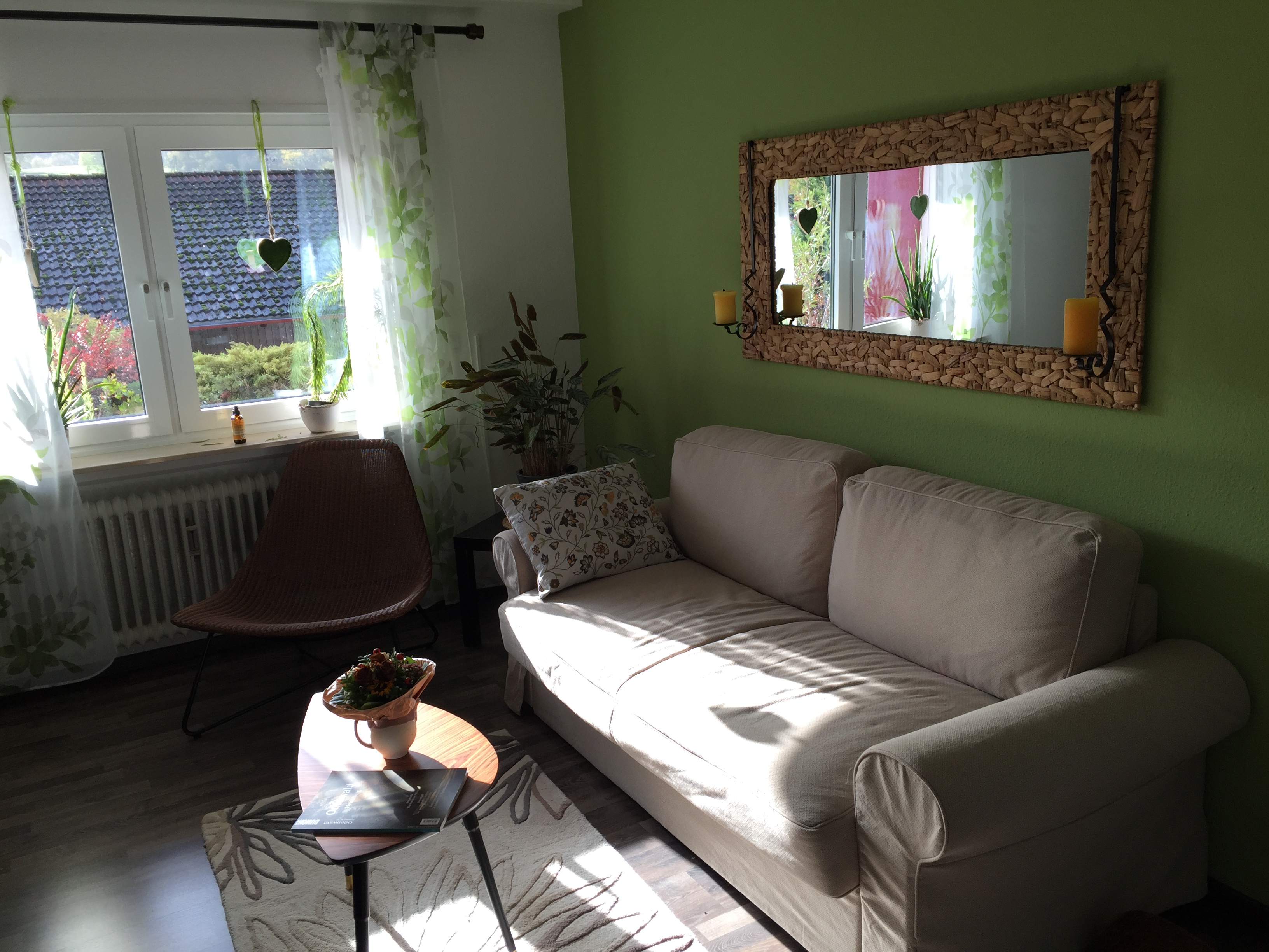 Bright sitting room with large mirror and sofa